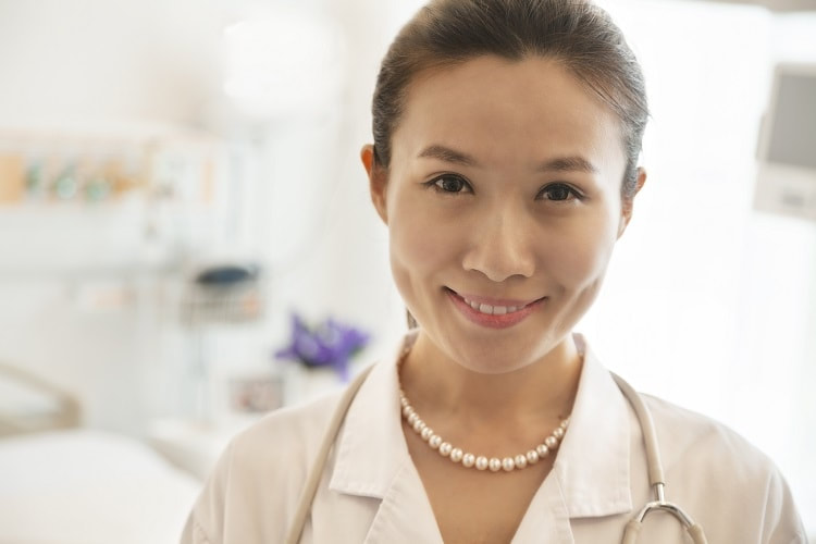 An attractive acupuncturist smiling