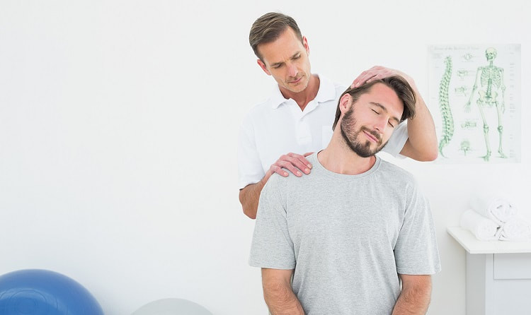 A patient is having his neck adjusted by a chiropractor